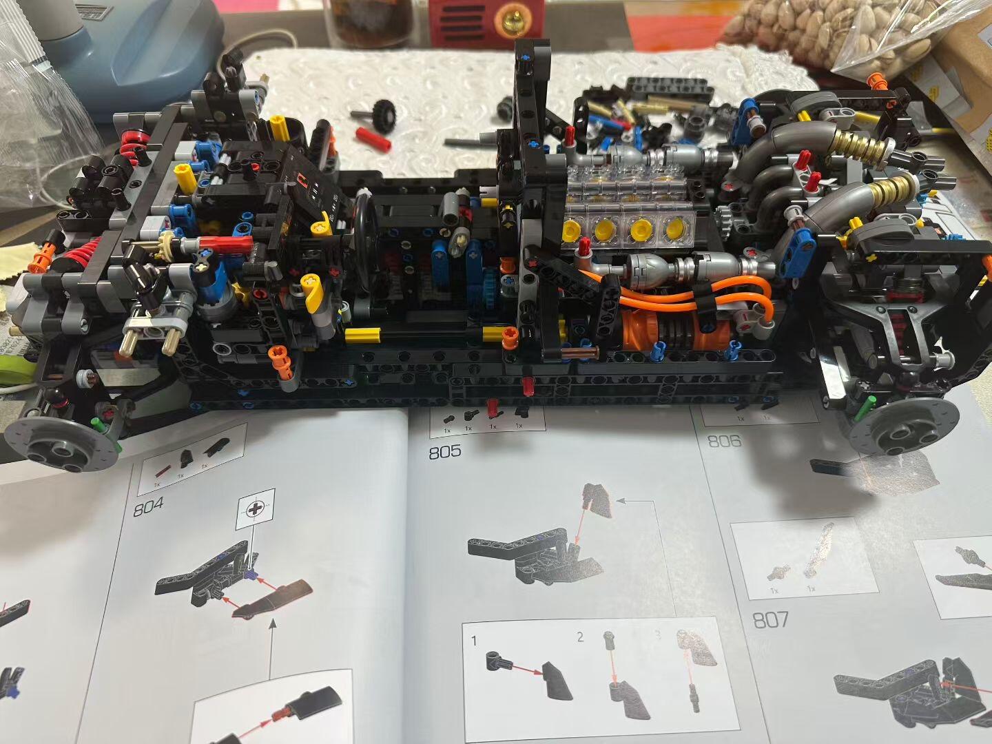 Manual open to chassis pages while the full underbody and drivetrain is assembled