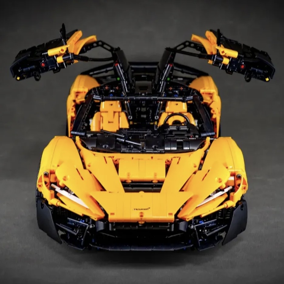 Orange MOC 03 front view with doors open, showing McLaren-inspired hood