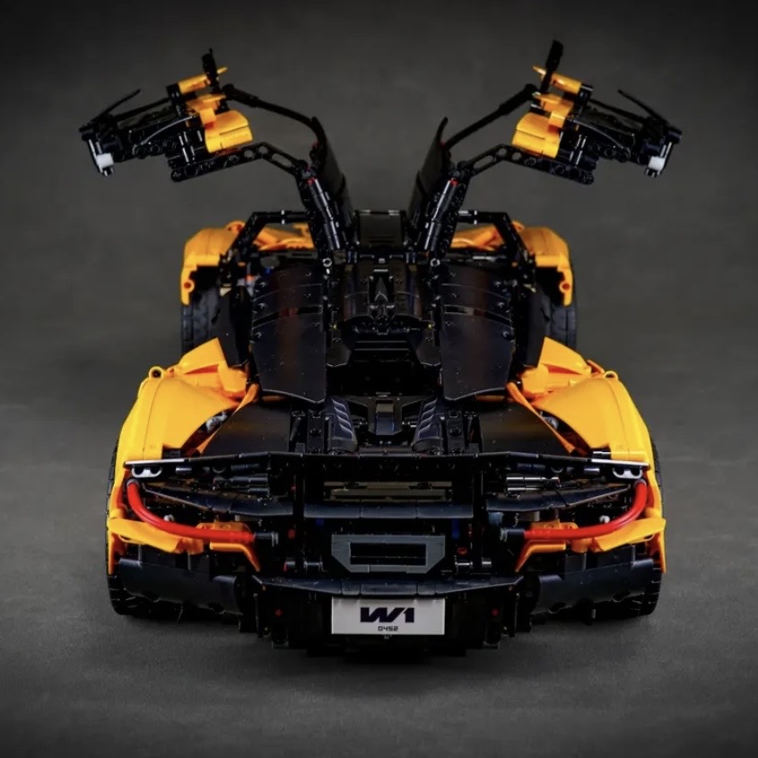 Orange MOC 03 rear view with W1 license plate and exposed engine bay