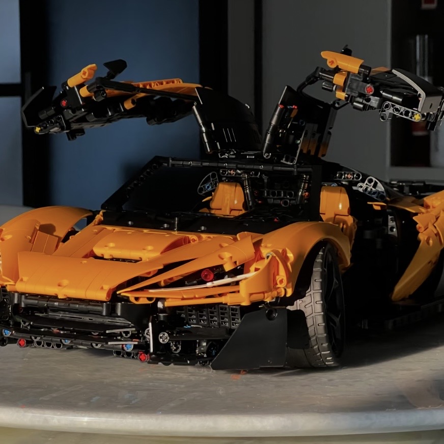 Orange MOC 03 three-quarter view with gullwing doors fully open
