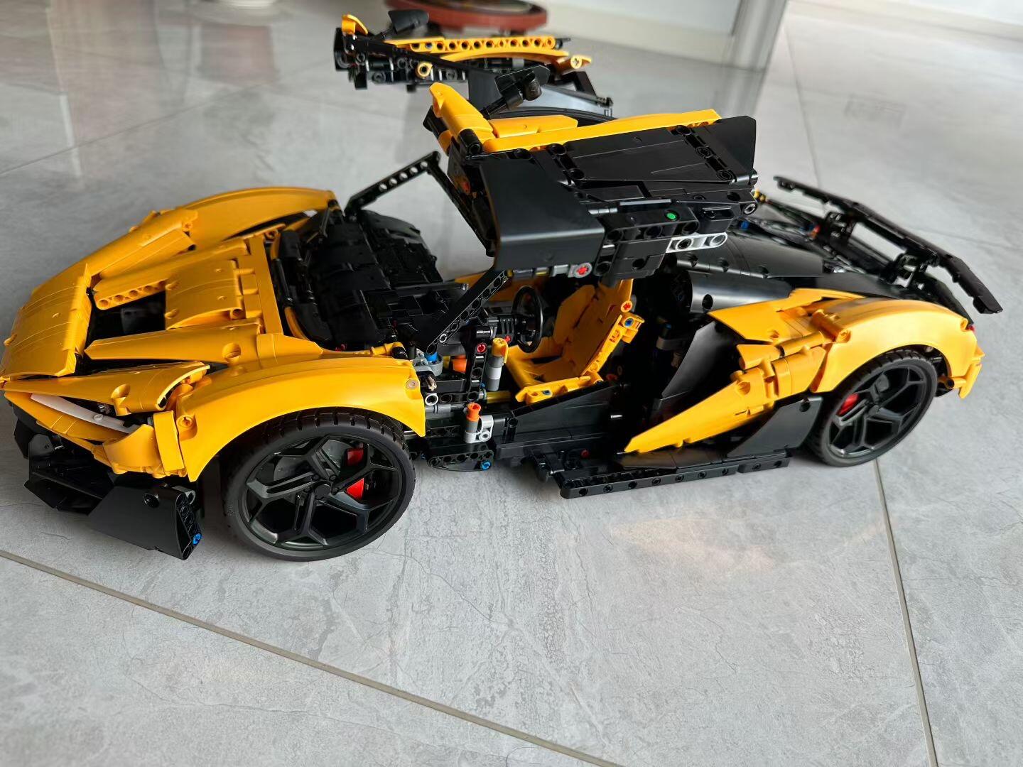 Yellow MOC 03 hero shot with doors and rear wing fully open on a tile floor
