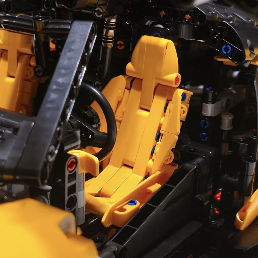 Yellow MOC 03 cockpit interior showing seat, steering wheel and shifter detail
